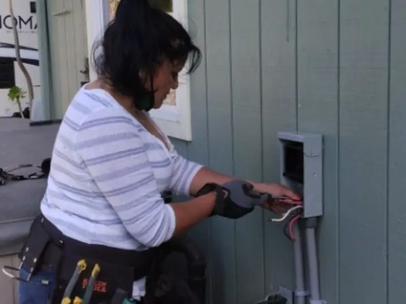 Licensed electrician wiring an exterior subpanel in Sanford